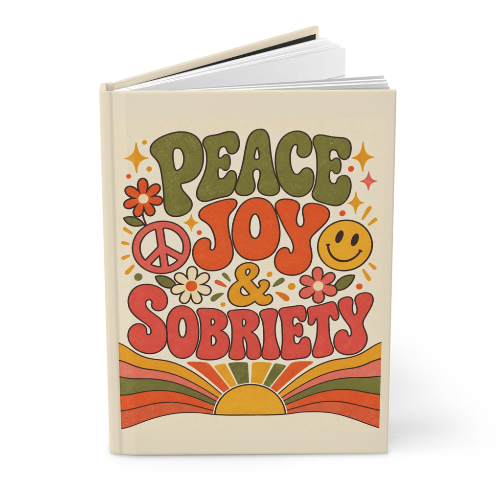 Peace, Joy & Sobriety journal standing open, showing the hardcover front and lined interior pages
