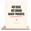 A vertical art print or card with a cream background and bold black text reading 'NOT DEAD. NOT DRUNK MAKIN' PROGRESS.