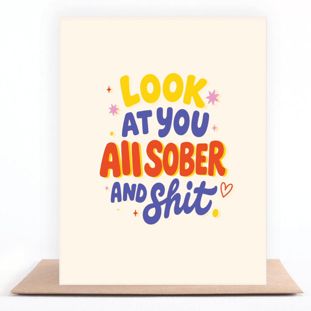 Colorful yellow, orange, and purple sobriety card reading “Look at You All Sober and Shit” displayed with a kraft envelope.