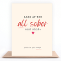 Funny cream, black, and red sobriety card reading “Look at You All Sober and Shit” and “Proud of You Always,” displayed with a kraft envelope.