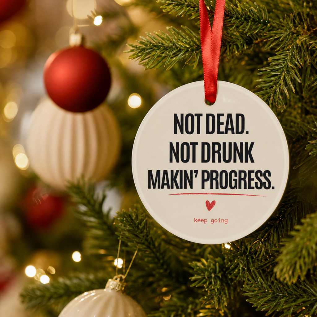 Close-up of the personalized sobriety ornament hanging on a Christmas tree branch by its red ribbon