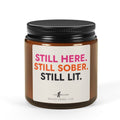 Still Here. Still Sober. Still Lit. sobriety candle in a 4 oz amber jar, Love & Recovery, front view